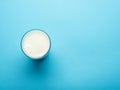 Glass of milk on the blue background. Top view. Royalty Free Stock Photo