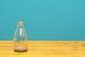 Glass milk bottle with dregs of chocolate milkshake