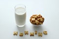 A glass of milk, a bowl of cookies with inscription from the cookies on the white background.