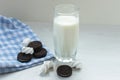 A glass of milk with chocolate chip cookies and a march of melow on a white table Royalty Free Stock Photo