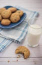 A glass of milk and a cookie with a bite taken out of it next to Royalty Free Stock Photo