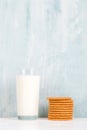 A glass of milk and cookies on the table, on a blue background, minimalism. Copy space Royalty Free Stock Photo