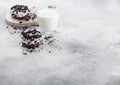 Glass of milk and doughnuts with black cookies on stone kitchen table background. Space for text Royalty Free Stock Photo