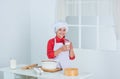 glass of milk. happy child cooking in kitchen. bake cookies in kitchen. professional and skilled baker. kid in chef Royalty Free Stock Photo