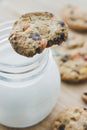 Glass of milk and homemade sugar cookies with colorful chocolate candies on a wooden board. Royalty Free Stock Photo