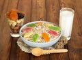 Glass of milk, oatmeal, dried fruit and nuts on background dark wood Royalty Free Stock Photo