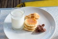 Glass of milk, Pancake and Chocolate cereal on white dish for br Royalty Free Stock Photo