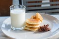 Glass of milk, Pancake and Chocolate cereal on white dish for br Royalty Free Stock Photo