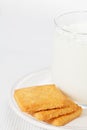 Glass of milk on the plate with cookies