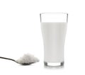 Glass of milk with sugar on white background