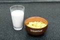 Glass of milk on a table and a bowl of flakes Royalty Free Stock Photo