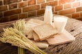 Glass of milk and whole wheat bread on the wooden board