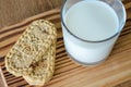 Glass of milk with wholegrain cookies on wooden desk. top view.