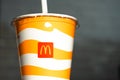 A glass with a milkshake or a cold drink with a McDonald`s logo close-up. Fast food restaurant chains. Russia, Kaluga, March 21,