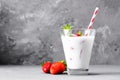 Glass of milkshake with strawberries and mint on a concrete surface. Kefir cocktail with strawberries and banana. close-up. Royalty Free Stock Photo