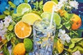 Glass of mineral water with straw. Lemon and lime slices on a blue background. Close-up illustration. Generative AI Royalty Free Stock Photo