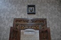 Glass mirror with a classic carved wooden frame shaped like a window