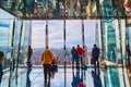 Glass mirror room overlook with tourists high up over New York City looking at Manhattan skyline