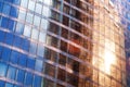 Glass mirror skyscraper wall with blue sky and red sunlight reflection close up, modern business center view Royalty Free Stock Photo