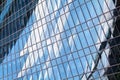 Glass mirror skyscraper wall with blue sky and white clouds reflection close up, modern business center view Royalty Free Stock Photo