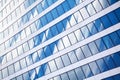 Glass mirror skyscraper wall with blue sky and white clouds reflection close up, modern business center view Royalty Free Stock Photo