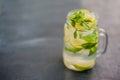 Glass of mojito with lime and mint ice cube close-up on dark wood background Royalty Free Stock Photo