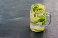 Glass of mojito with lime and mint ice cube close-up on dark wood background Royalty Free Stock Photo