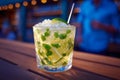 A glass of mojito on a wooden table with a straw in it Royalty Free Stock Photo