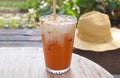 Glass of Mouthwatering Thai Iced Tea Isolated on Garden Table Royalty Free Stock Photo