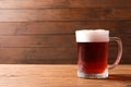 Glass mug with cold red beer on table Royalty Free Stock Photo