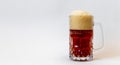 Glass mug full of a red beer with a foam cap Royalty Free Stock Photo