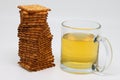 Glass mug of green tea and stack of cookies, diet, nutrition, background
