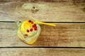 Glass mug of lemonade with ice lemon slice and pomegranate fruits and a drinking can on a wooden table, top view Royalty Free Stock Photo