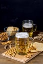 Glass Mug of Tasty Light Beer and Snacks on Wooden Table Pretzel Cracker with Solt Vertical Royalty Free Stock Photo