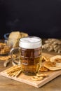 Glass Mug of Tasty Light Beer and Snacks on Wooden Table Pretzel Cracker with Solt Vertical Royalty Free Stock Photo