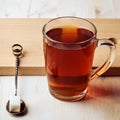 Glass mug with tea and teaspoon with sugar Royalty Free Stock Photo