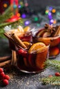 Glass mugs of mulled wine with spices and citrus fruits. Traditional hot drink or beverage, festive cocktail at X-mas or New Year Royalty Free Stock Photo