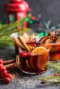 Glass mugs of mulled wine with spices and citrus fruits. Traditional hot drink or beverage, festive cocktail at X-mas or New Year Royalty Free Stock Photo