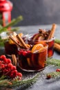 Glass mugs of mulled wine with spices and citrus fruits. Traditional hot drink or beverage, festive cocktail at X-mas or New Year Royalty Free Stock Photo