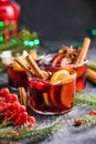 Glass mugs of mulled wine with spices and citrus fruits. Traditional hot drink or beverage, festive cocktail at X-mas or New Year Royalty Free Stock Photo