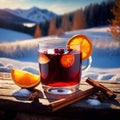 Glass of mulled red wine against snowy winter landscape