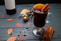 Glass of mulled wine, bottle of wine and corkscrew with open cork on wooden table. Royalty Free Stock Photo