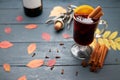 Glass of mulled wine, bottle of wine and corkscrew with open cork on wooden table. Royalty Free Stock Photo