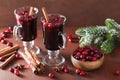 Glass of mulled wine with cranberry and spices, winter drink