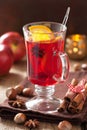 glass of mulled wine with orange and spices, christmas decoration