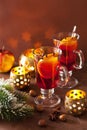 glass of mulled wine with orange and spices, christmas decoration background