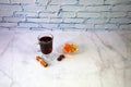 A glass of mulled wine with slices of orange, cinnamon sticks, star anise and dried fruit Royalty Free Stock Photo