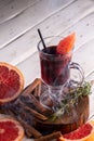Glass of mulled wine. Spicy citrus warming Autumn and winter drink on white background