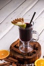 Glass of mulled wine. Spicy warming Autumn and winter drink on light background