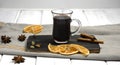 A glass of mulled wine on a wooden board with cinnamon sticks and dried orange. Horizontal orientation Royalty Free Stock Photo